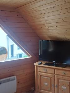 a living room with a large television and a window at Holiday Home Fleesensee in Göhren-Lebbin +11 photos