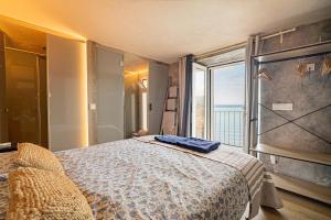 a bedroom with a large bed with a large window at Villa Ca La Dolors - Cala Deià, by PriorityVillas in Deia