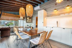 a kitchen and dining room with a wooden table and chairs at Villa Ca La Dolors - Cala Deià, by PriorityVillas in Deia +49 photos