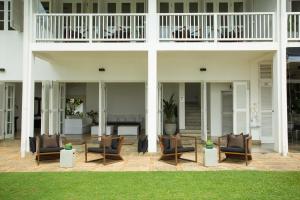 a patio with chairs and a fireplace on a house at Arabella on Boossa in Galle +142 photos