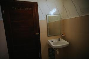 a bathroom with a sink and a mirror at Tiffany Garden in Mangsit +24 photos