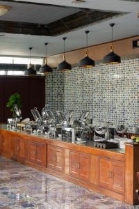 a kitchen with a counter with pots and pans at Le Erawan Phang Nga Hotel in Phangnga +72 photos