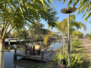 a table on a wooden bridge over a body of water at The Orchid Resort & Relax in Maha Sarakham