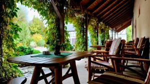 a wooden table and chairs on a patio at Richzenhainer-Hof in Waldheim