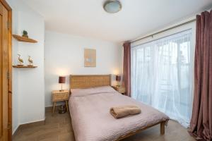 a bedroom with a bed and a large window at Shannon View Jungle House in Athlone