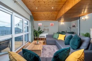 a living room with a couch and a table at Shannon View Jungle House in Athlone