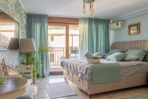a bedroom with a bed with green curtains and a table at Centre Budva Blue in Budva