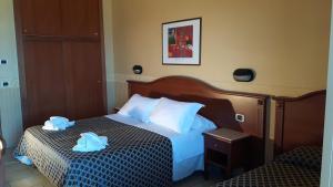Postel nebo postele na pokoji v ubytování Hotel Grifone + 37 fotografií