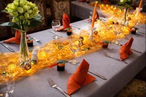 a table with a long yellow table cloth with candles at Richzenhainer-Hof in Waldheim
