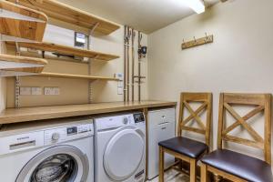 a laundry room with a washer and dryer at Long Barn in Ludlow