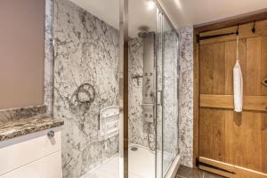a shower with a glass door in a bathroom at Long Barn in Ludlow +10 photos
