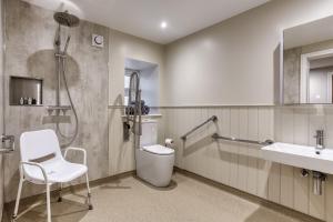 a bathroom with a shower and a toilet and a sink at Hill Top Farm in Penrith +25 photos