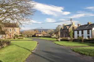 an empty street in a village with houses at Hill Top Farm in Penrith