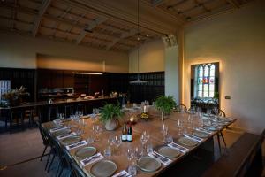 a long table with plates and wine glasses in a room at Denton Hall in Ilkley