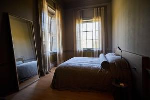 a bedroom with a bed and a large window at Denton Hall in Ilkley