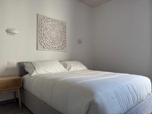 a white bed in a bedroom with a picture on the wall at Dimora degli Ulivi in Rimini +36 photos