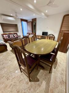 a dining room with a wooden table and chairs at Shobhalay- Premium 2BHK Parking prime location super interior in Rānchī +13 photos