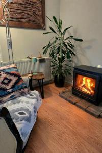 a living room with a fireplace and a couch at Whispering O - B&B Ermelo Speuld On the Veluwe in Ermelo