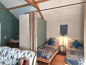a room with two beds and a refrigerator at Whispering O - B&B Ermelo Speuld On the Veluwe in Ermelo