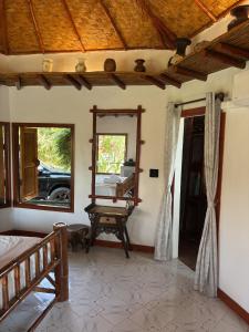 a bedroom with a mirror and a bed and a window at The Orchid Resort & Relax in Maha Sarakham