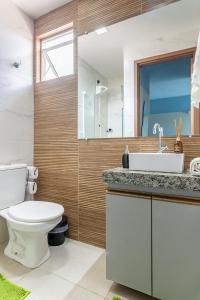 a bathroom with a toilet and a sink at Flat Coqueiros 101 Praia in Tamandaré