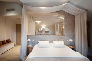 a bedroom with a canopy bed with two mirrors at Domaine de Barthas in Castelnau-Magnoac +51 photos
