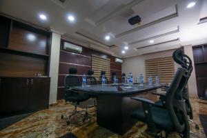 a conference room with a table and chairs in it at Joygate Hotels & Suites in Lagos