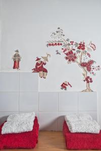 a room with two red ottomans and a tree on the wall at Château du Hardas in Segré +66 photos
