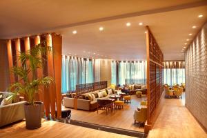 a hotel lobby with couches and tables and chairs at Zeus Wyndham Grand Athens in Athens +56 photos