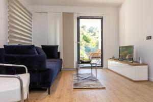 a living room with a blue couch and a table at Villa Mauro in Božava
