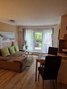 a living room with a couch and a table at Lange Str. 15 - Ferienwohnung in Prerow