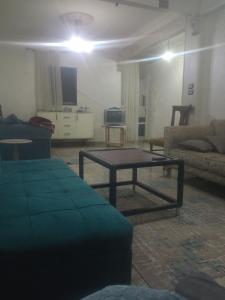 a living room with a table and a couch at Al Sawy Station in Cairo