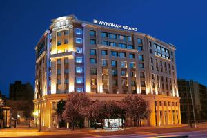 a building with a sign on top of it at Zeus Wyndham Grand Athens in Athens