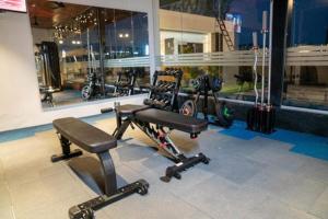 a room with a gym with machines and motorcycles at CS Luxurio Presendential Suites Gachibowli in Hyderabad