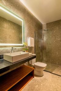 a bathroom with a sink and a toilet and a shower at Tivoli Maiorana Belém Pará Hotel in Belém +31 photos