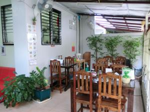 a dining room with tables and chairs in a restaurant at Wayside Guesthouse in Chiang Mai