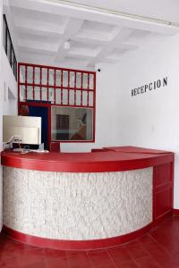 a red counter in a room with a sign on the wall at Hotel Montecarlo by Croma in Santiago
