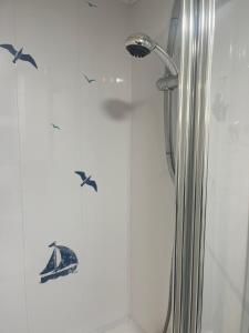 a shower with bird stickers on the side of it at The Snug - All Seasons Chalet Breaks in Leysdown-on-Sea +20 photos