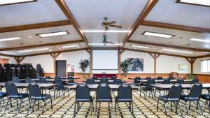a large room with tables and chairs and a ceiling at Motel 6 Minot, ND in Minot +21 photos