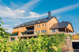a large building on top of a hill at Le Relais D'Orti in Sainte-Ode