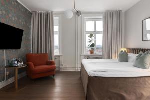 a hotel room with a bed and a chair at Grand Hotel Jonkoping, BW Signature Collection in Jönköping