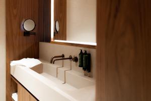a bathroom with a sink and a mirror at Le Relais D'Orti in Sainte-Ode +31 photos