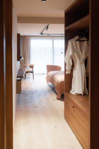 a bedroom with a bed and a desk at Le Relais D'Orti in Sainte-Ode