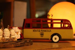 a toy bus and figurines on a table at Minshuku Asogen in Aso