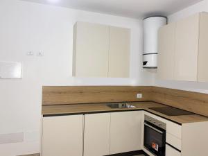 a kitchen with white cabinets and a sink at Ugo Bassi 98 in Cento