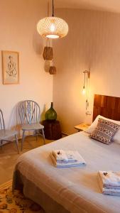 a bedroom with a bed with towels on it at Il Verdone in Usini +68 photos
