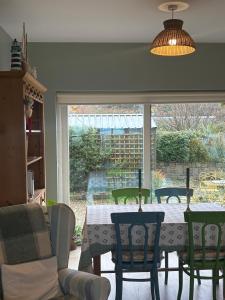 a dining room with a table and chairs and a window at Croagh Patrick Lodge Apartment in Westport