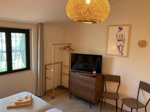 a bedroom with a tv on a dresser and a bed at Il Verdone in Usini