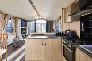 a kitchen in an rv with a sink and a stove at Host & Stay - 10th Avenue in Morpeth