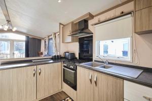 a kitchen with a sink and a stove top oven at Host & Stay - 10th Avenue in Morpeth